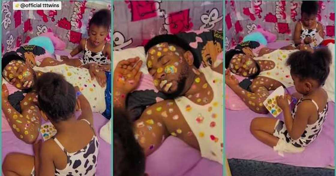 Twin girls decorate their father's body with stickers at home Twin girls decorate their father's body with stickers at home