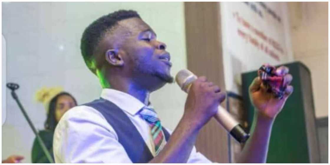 Ebenezer Ayeni holding a microphone. Ebenezer Ayeni holding a microphone.