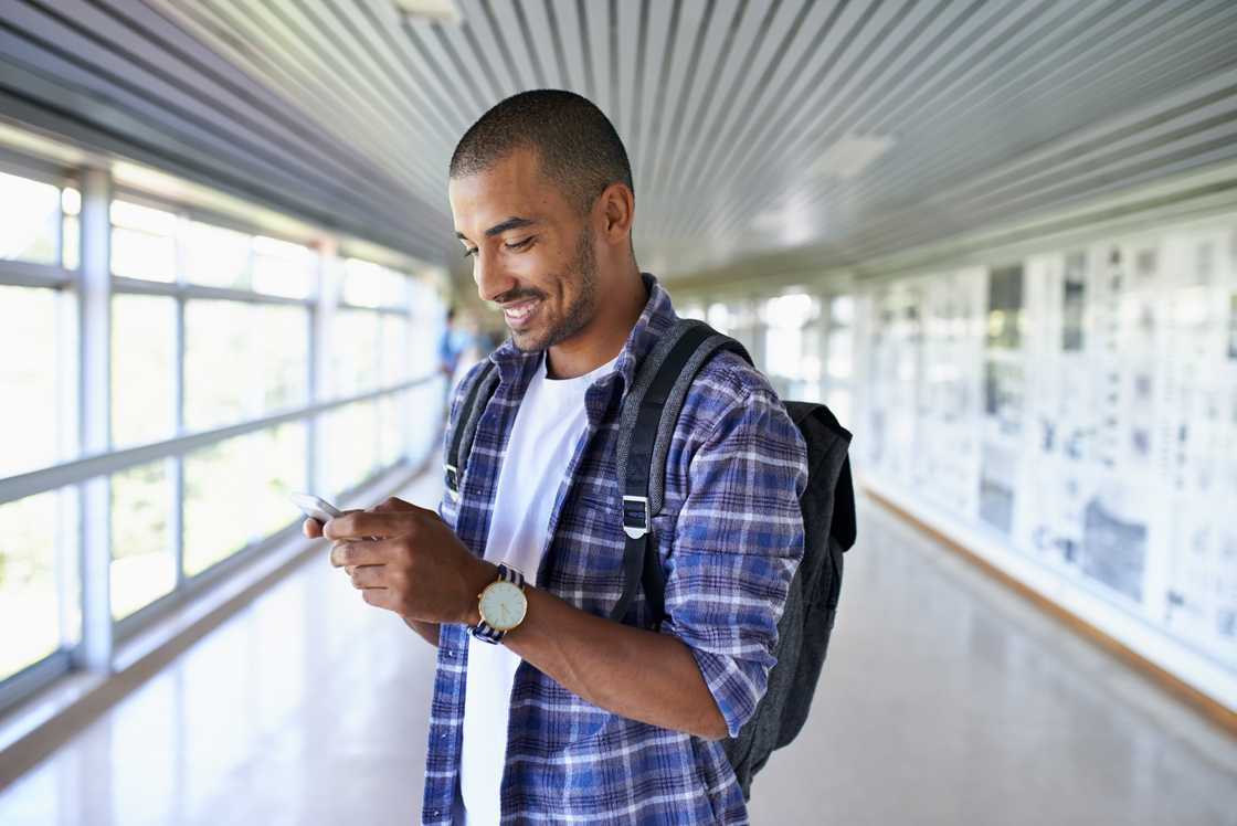 A student using a phone to download the CBT app