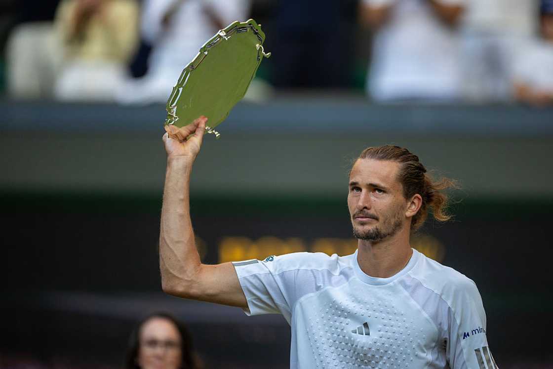 Alexander Zverev holds a trophy Alexander Zverev holds a trophy