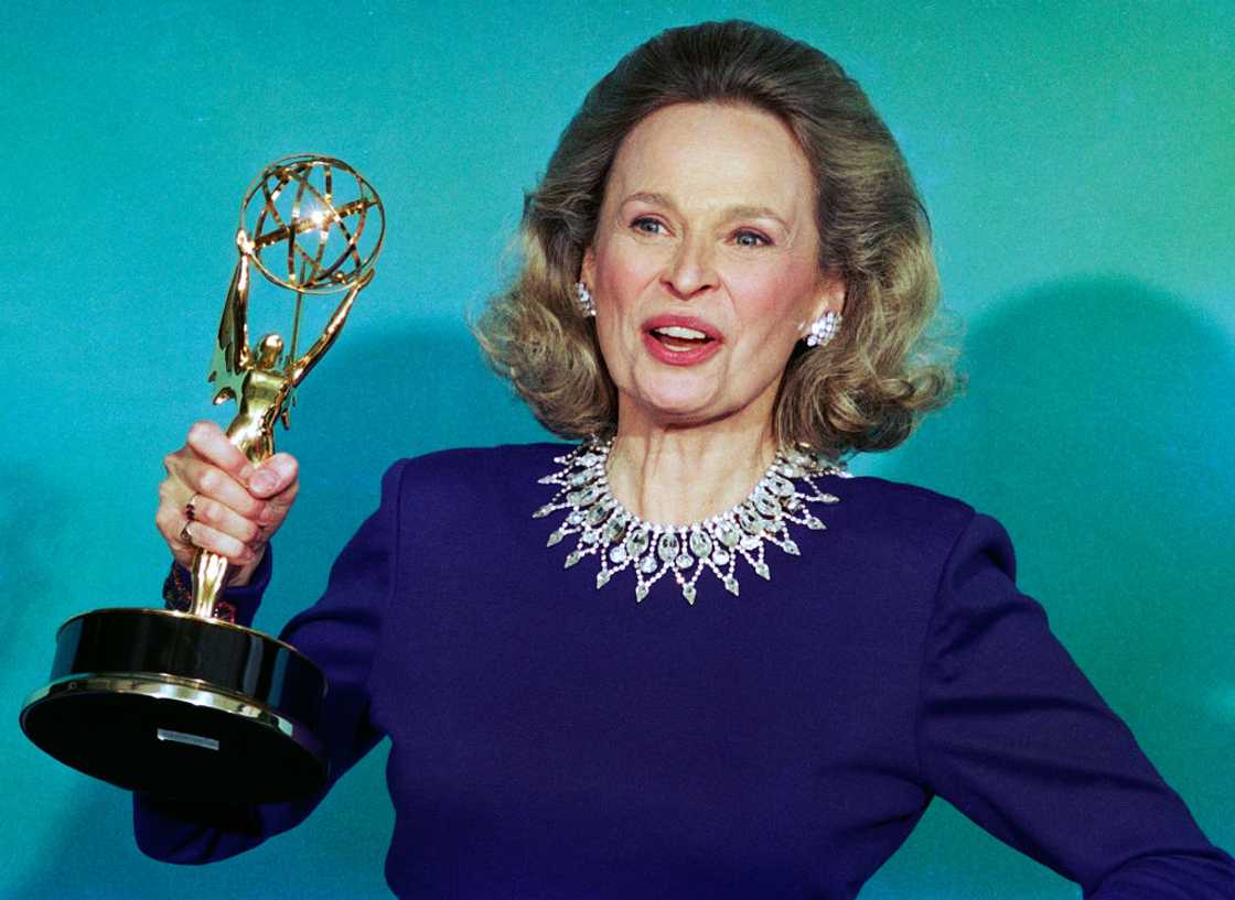 Actress Bonnie Bartlett backstage holding her Emmy Award trophy