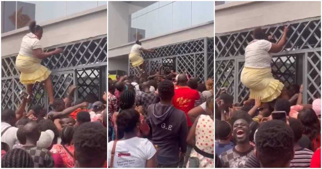 Nigerian woman climbs bank gate, video of woman climbing gate Nigerian woman climbs bank gate, video of woman climbing gate