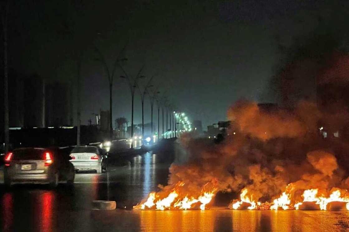 Tyres burnt at a road blockade during overnight protests in the Libyan capital Tripoli Tyres burnt at a road blockade during overnight protests in the Libyan capital Tripoli