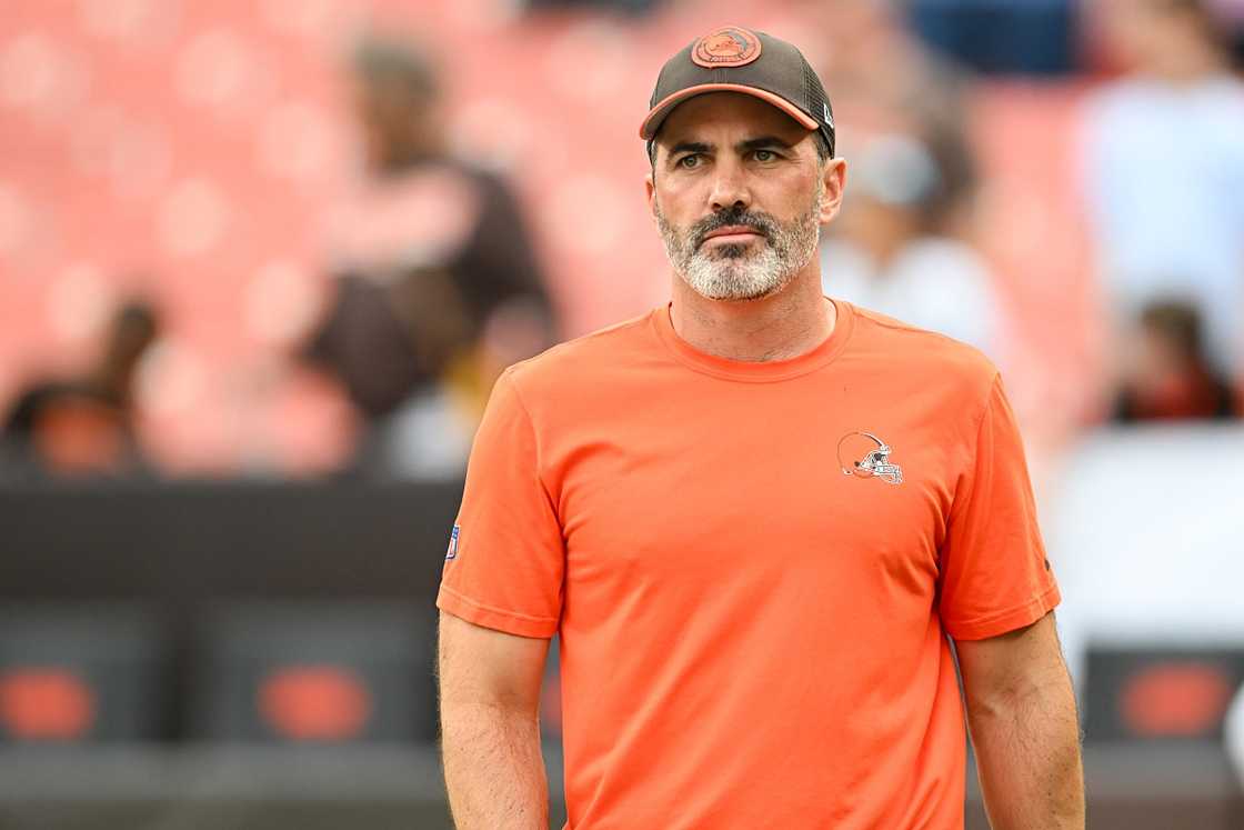 Kevin Stefanski is pictured on a field in an orange outfit.