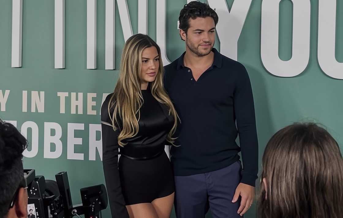 Iris Kendall and TJ Palma pose on the red carpet of a film premiere
