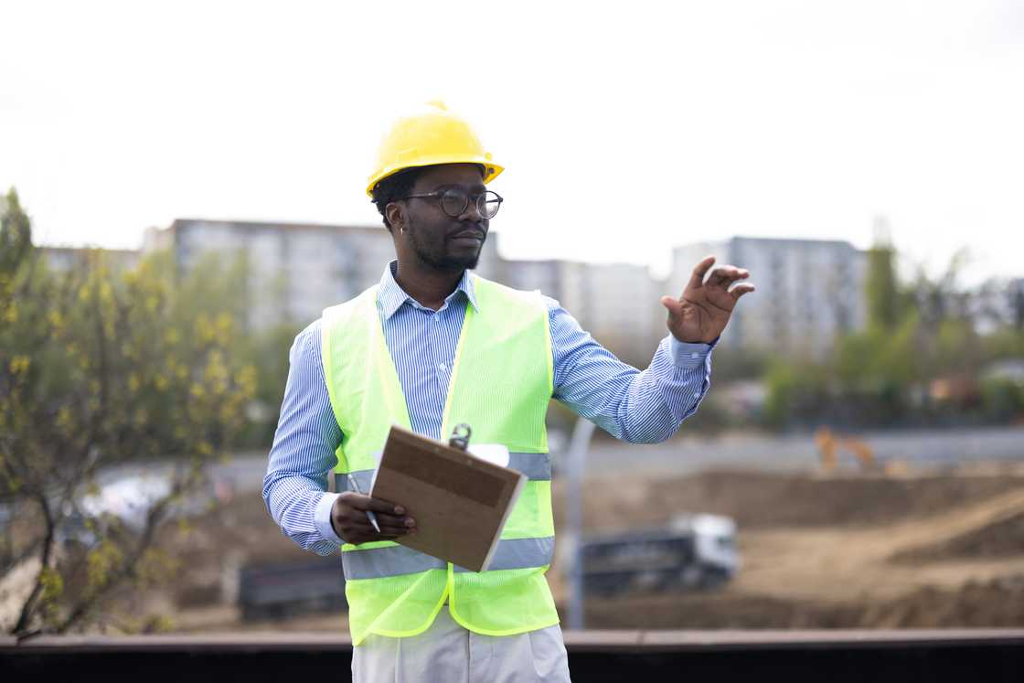 A young engineer supervises a construction site A young engineer supervises a construction site