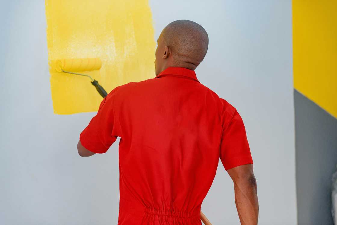 A man painting his house
