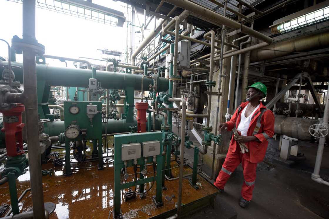 A worker examines an oil port.