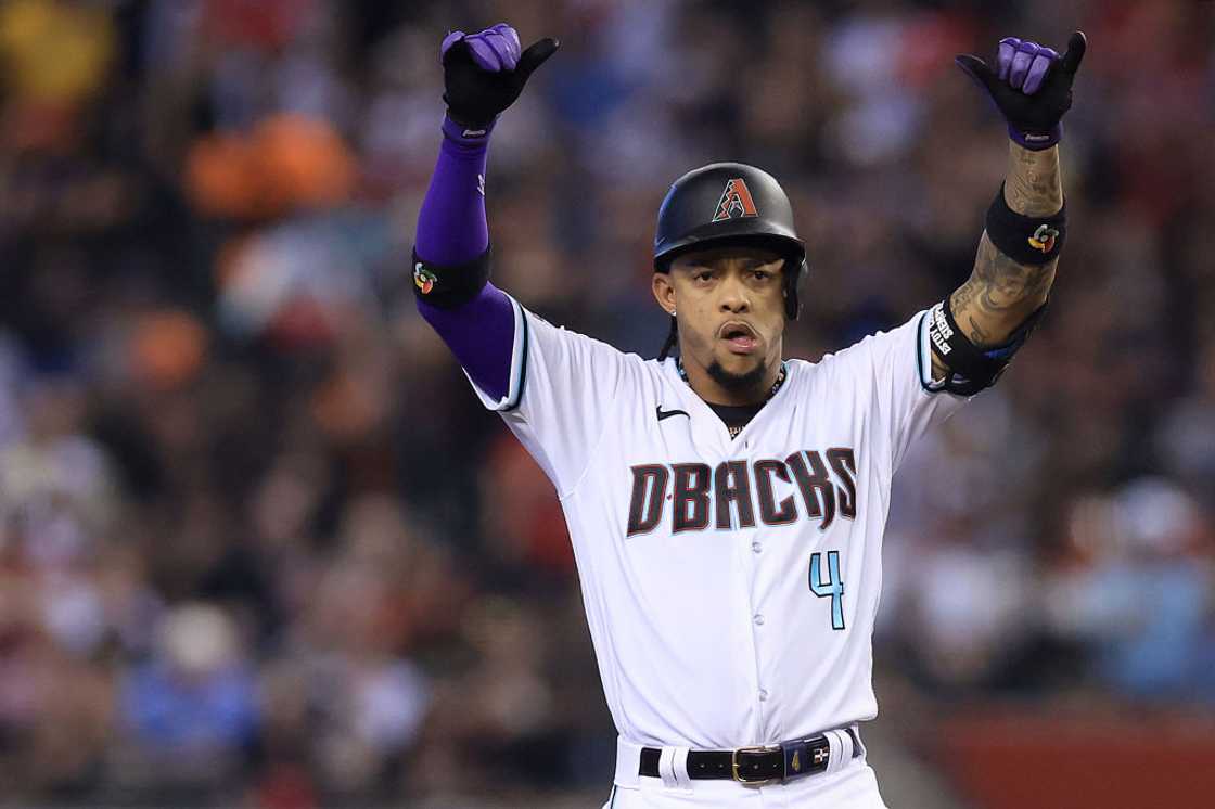 Ketel Marte celebrates on second base after hitting a double against Ranger Suarez #55