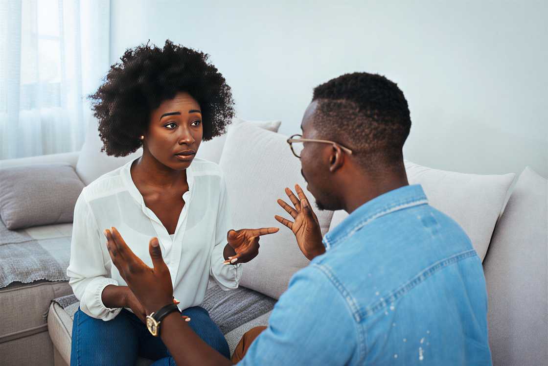 An angry young couple sits on the couch An angry young couple sits on the couch