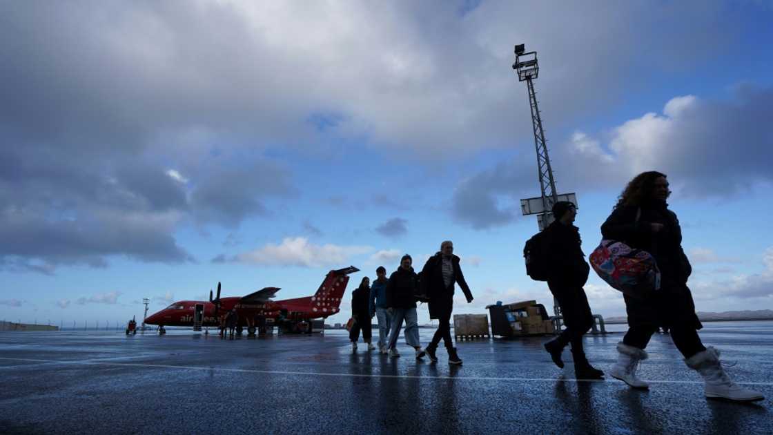 Passengers disembarking at the airport of Nuuk, Greenland, which will soon the capacity for international flights Passengers disembarking at the airport of Nuuk, Greenland, which will soon the capacity for international flights