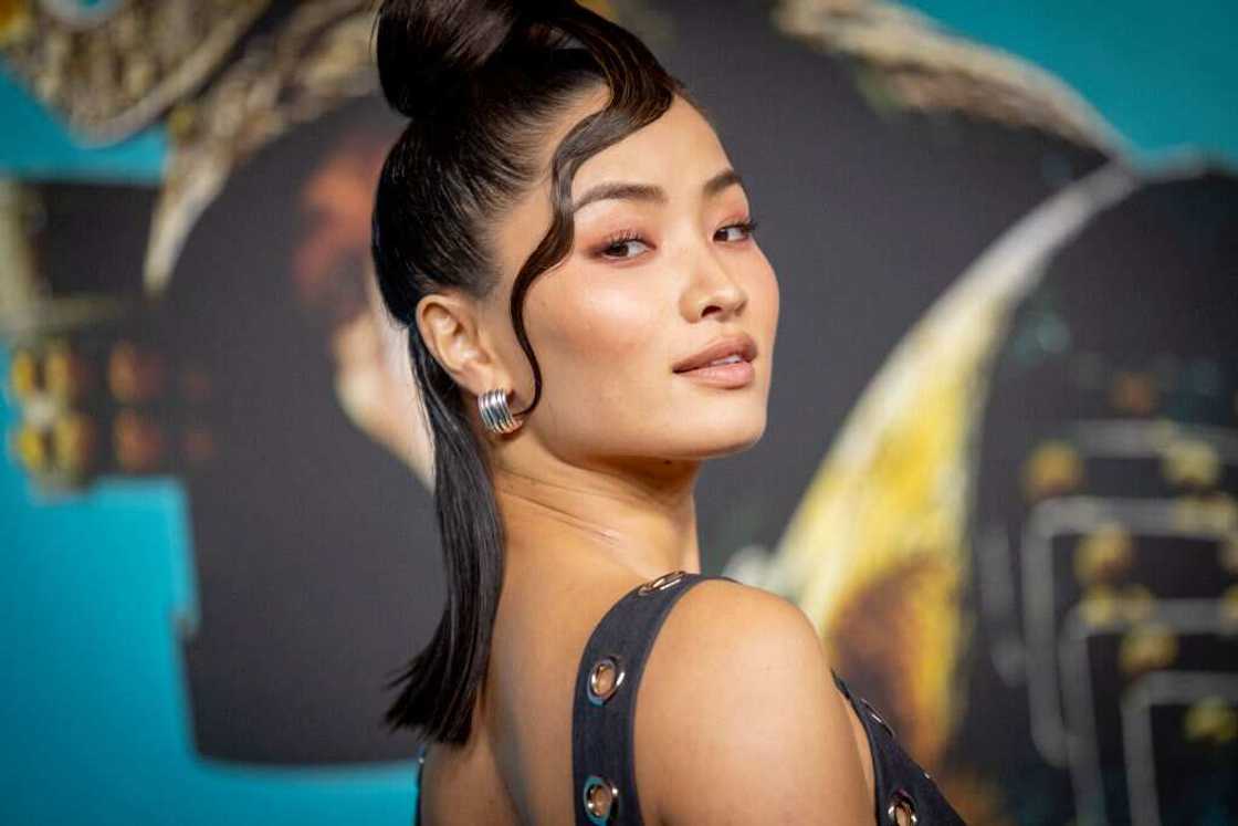 Anna Sawai posing for a photo in a black dress at the Los Angeles Premiere Of FX's "SHOGUN"