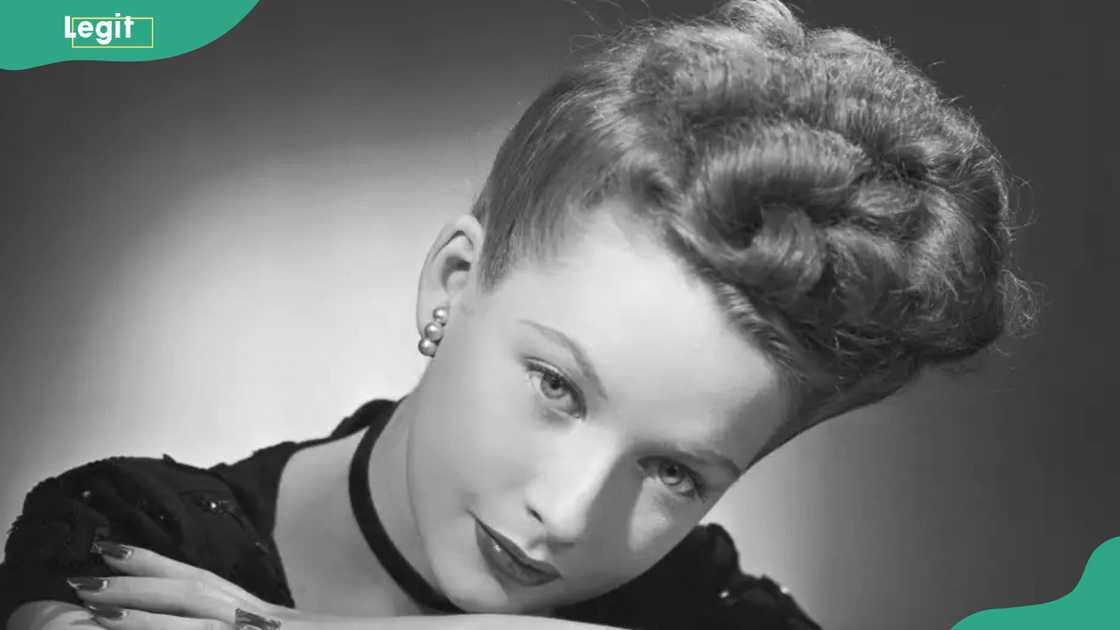 A woman displaying the 1920s upswept hairstyle A woman displaying the 1920s upswept hairstyle