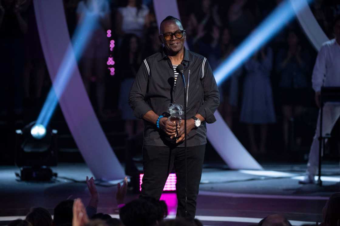 Randy Jackson on stage giving a speech as he presents an award Randy Jackson on stage giving a speech as he presents an award