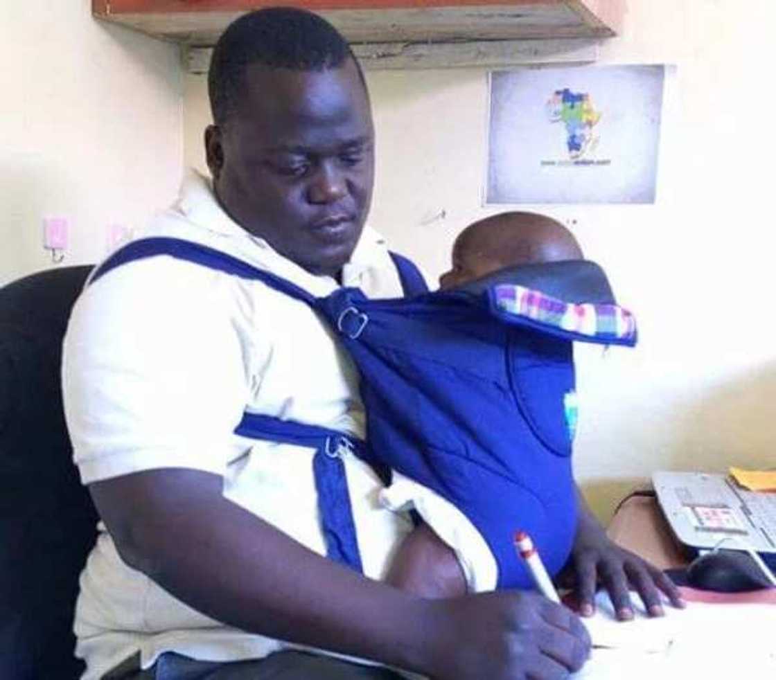 This man, said to be Silas Odhiambo from Kisumu, takes his baby to work This man, said to be Silas Odhiambo from Kisumu, takes his baby to work