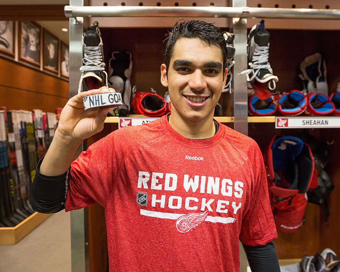 Athanasiou poses with his first NHL goal puck
