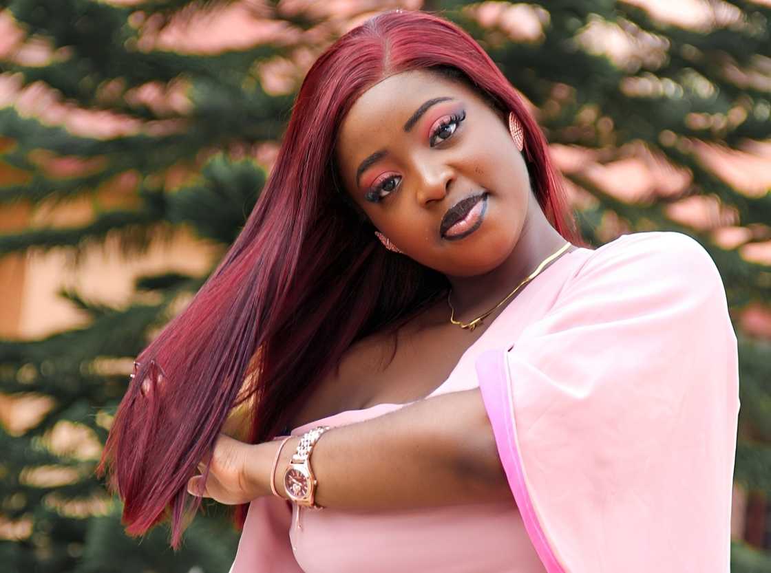 Kamsy Uzoma holds her hair in a pose. Kamsy Uzoma holds her hair in a pose.