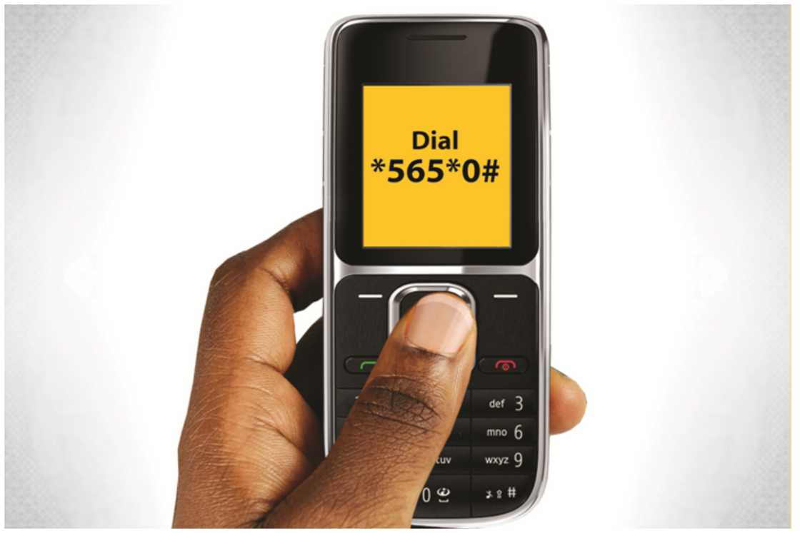 Someone holding a telephone  displaying the BVN USSD code