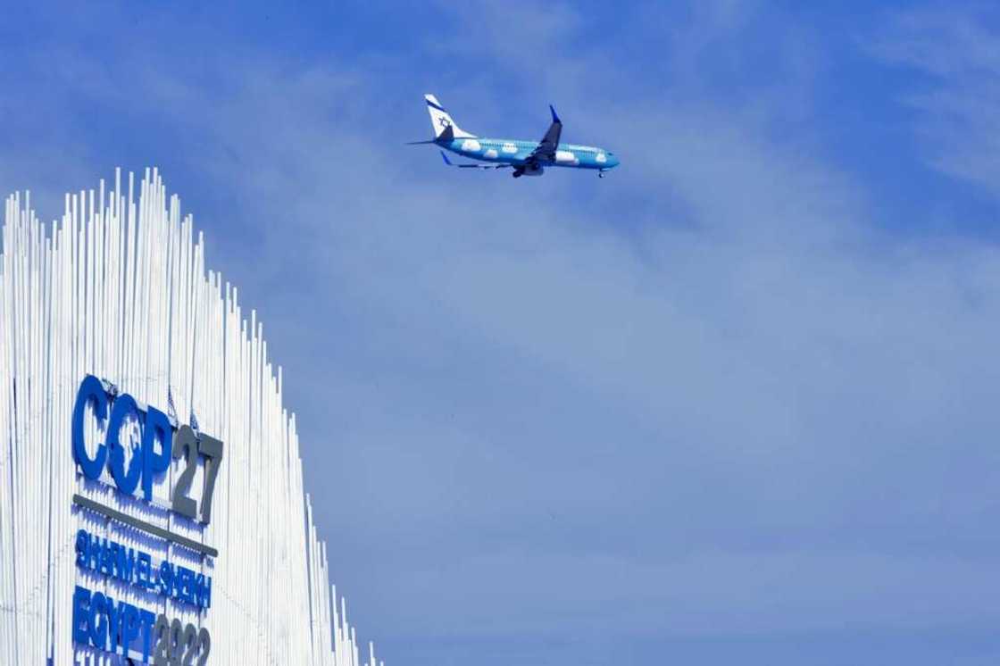 An airplane flies over the Sharm el-Sheikh International Convention Centre, during the COP27 climate conference in Egypt