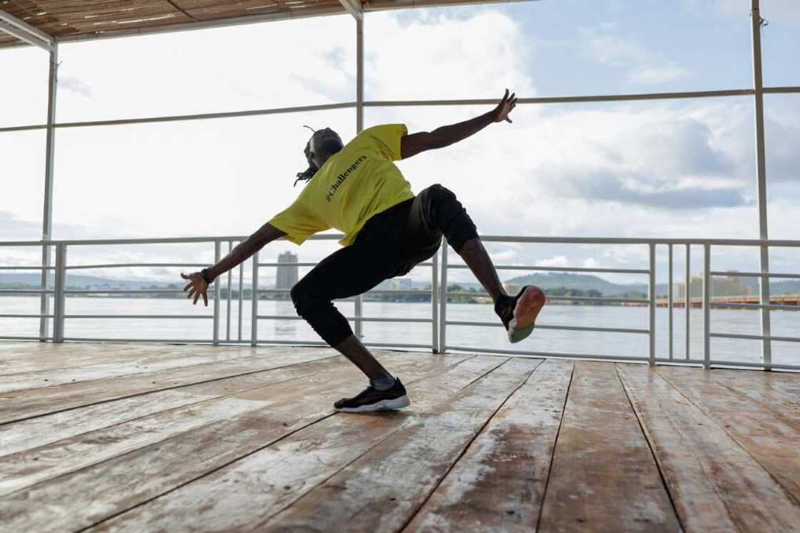 Limbering up: A dancer gets ready for showtime on Mali's floating arts venue Limbering up: A dancer gets ready for showtime on Mali's floating arts venue
