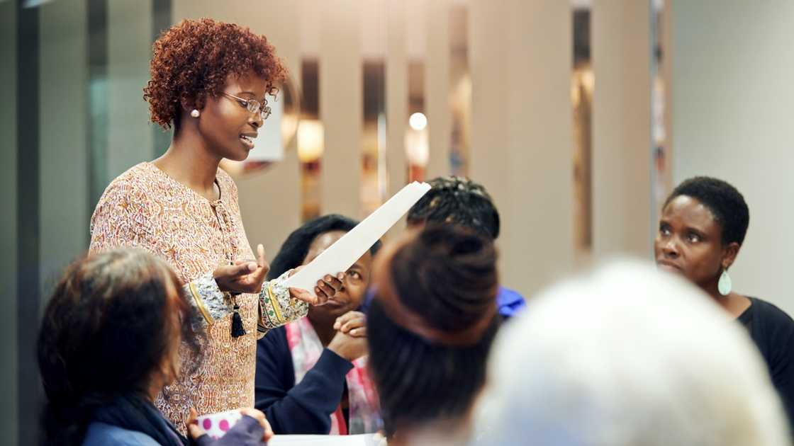 An African lecturer stands up during a session with students. An African lecturer stands up during a session with students.