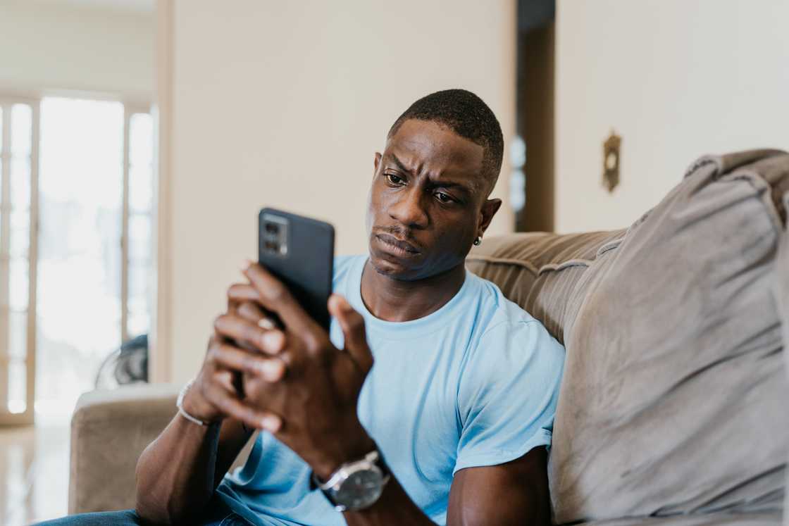 A man texts on his phone A man texts on his phone