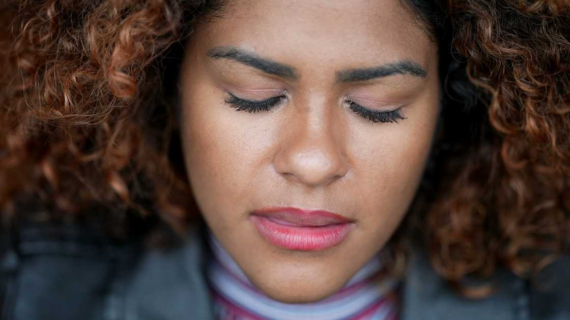A woman closing eyes in contemplation A woman closing eyes in contemplation