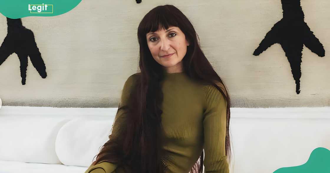 Scarlett Rouge poses in front of her painting