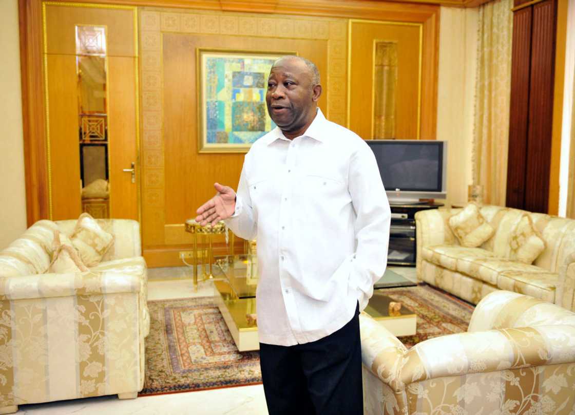 Man standing in a wealthy living room.