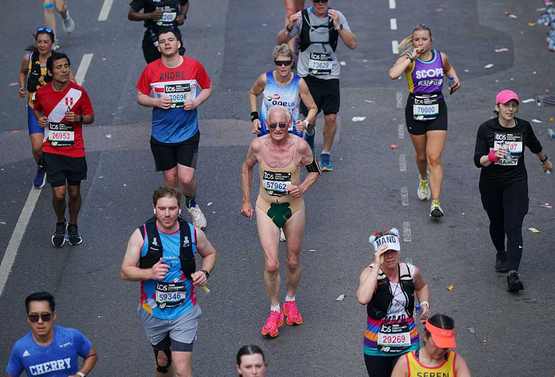 People running on the Isle of Dogs during the TCS London Marathon People running on the Isle of Dogs during the TCS London Marathon