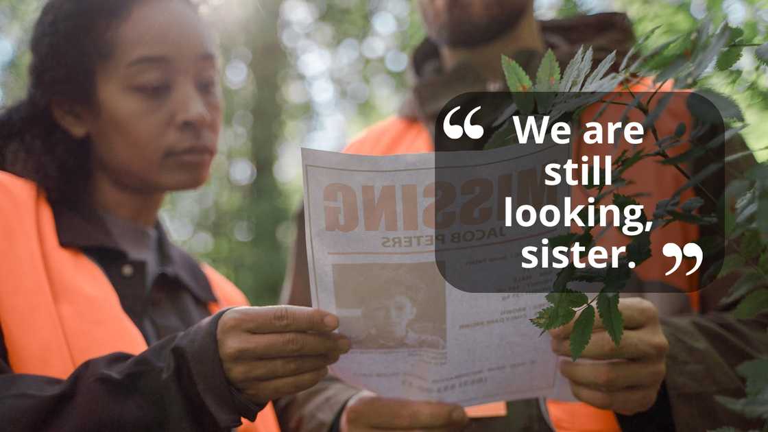 Two volunteers read a missing person poster outdoors. Two volunteers read a missing person poster outdoors.