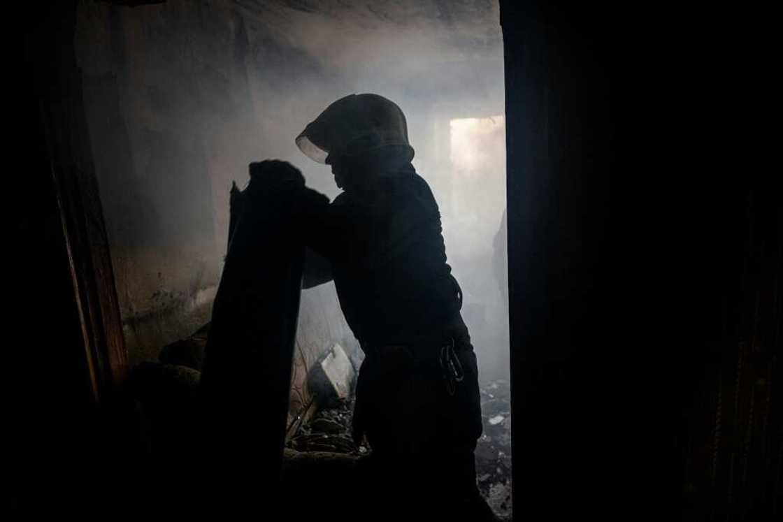 A Ukrainian firefighter removes a piece of a MLRS BM-27 Uragan missile from an apartment in Bakhmut on October 29 A Ukrainian firefighter removes a piece of a MLRS BM-27 Uragan missile from an apartment in Bakhmut on October 29