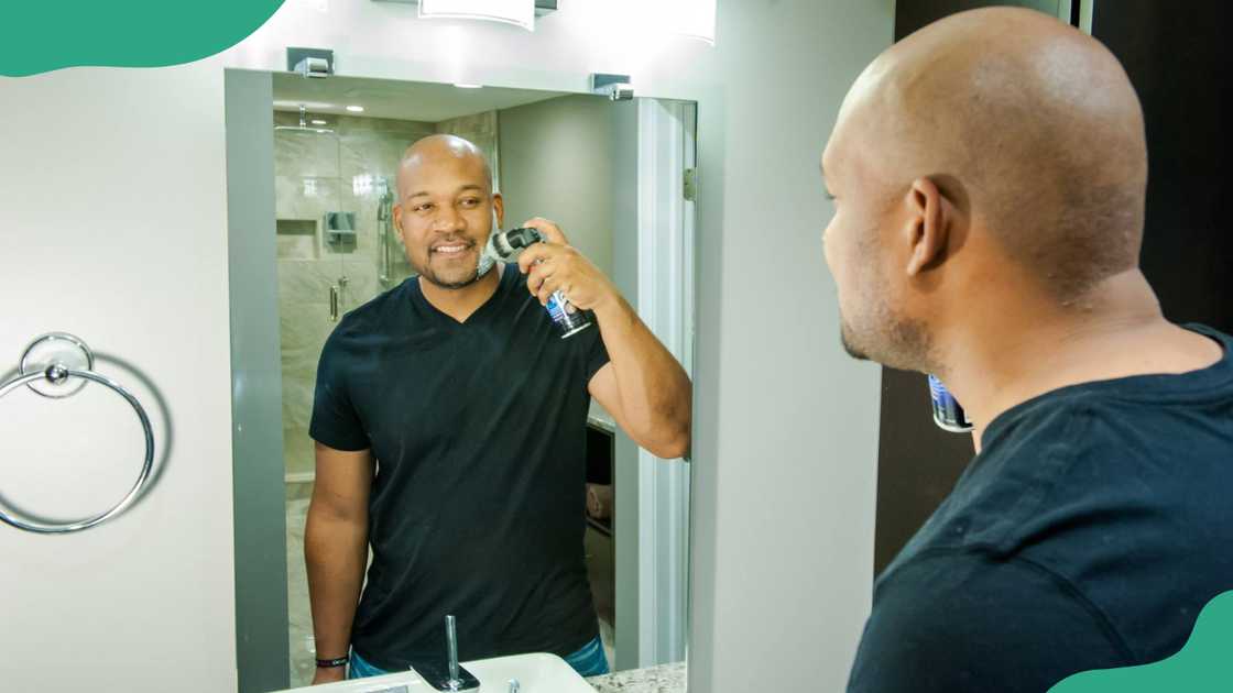 A man showcasing a Legacy Shave brush.