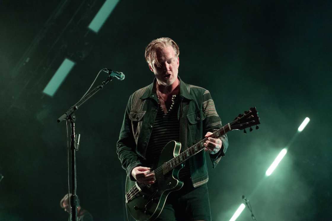 A member of the Queens Of The Stone Age performs on stage A member of the Queens Of The Stone Age performs on stage