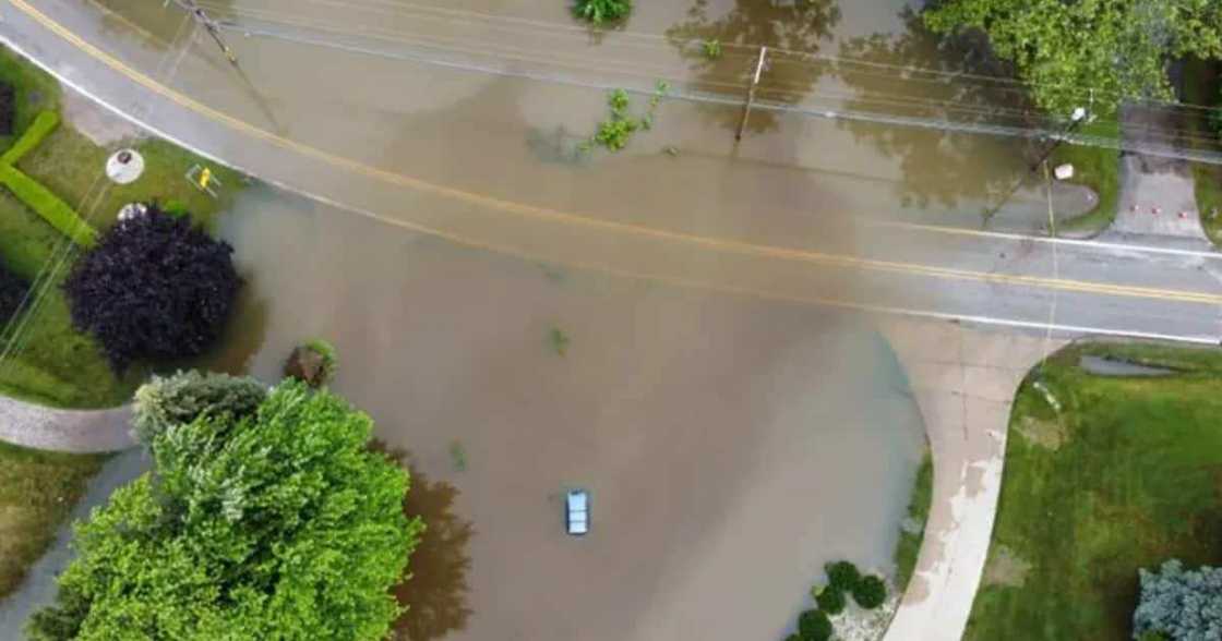 The woman was trapped inside her car which was in the middle of the flooding waters.