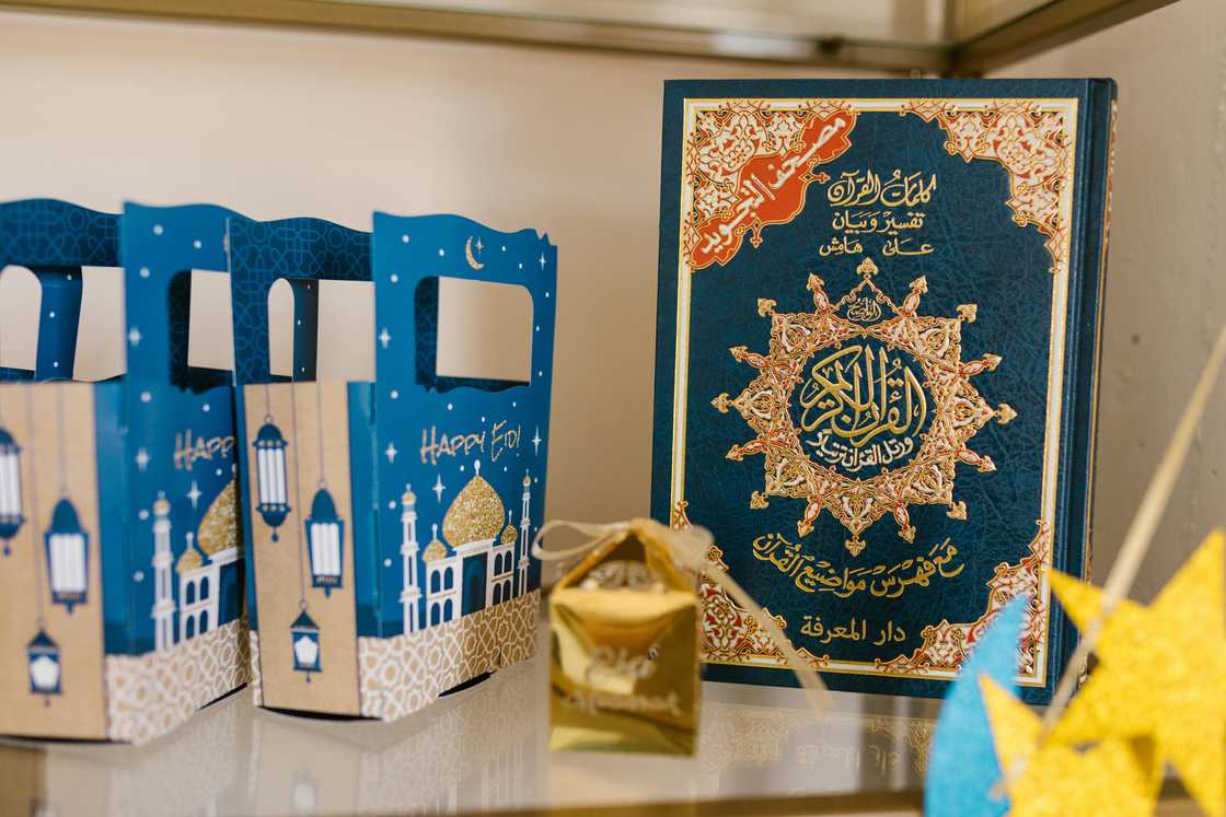 Blue and brown Eid giftboxes next to Eid decorations