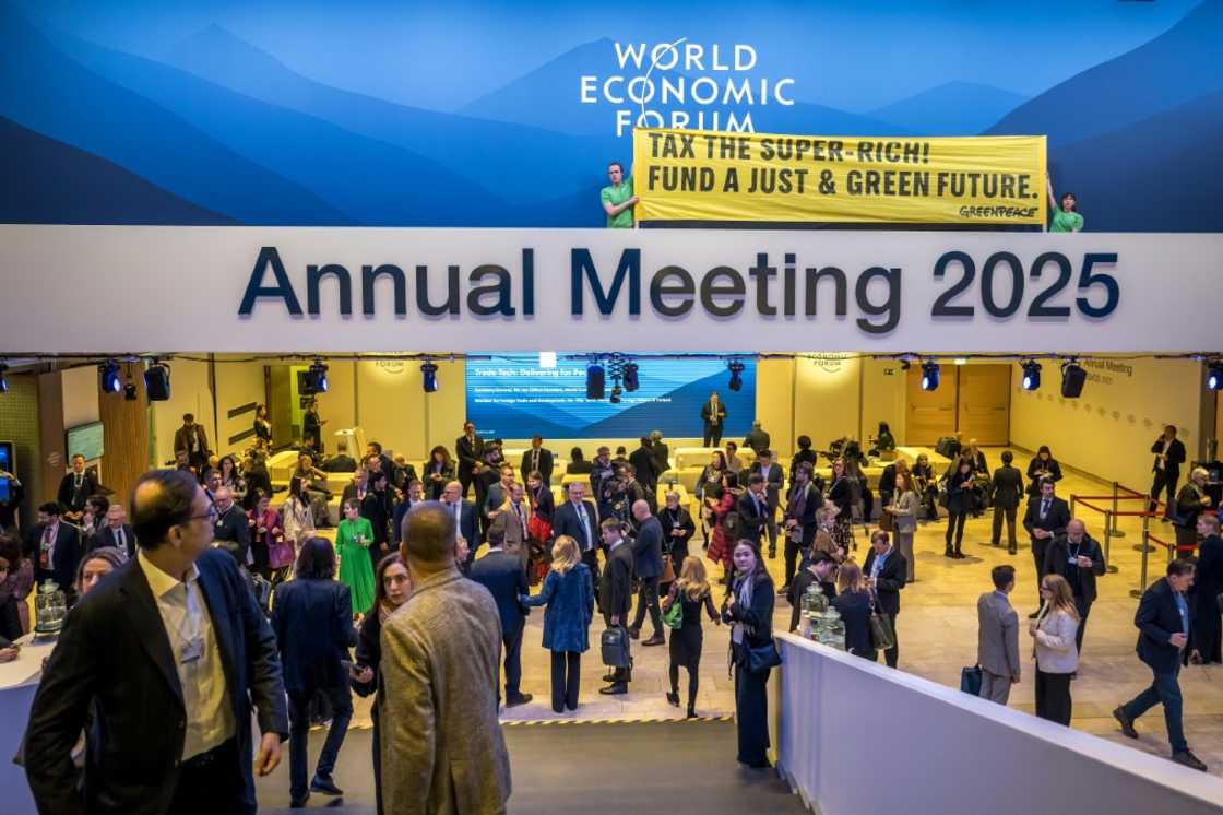 Greenpeace activists unfurled a banner demanding a tax on the super rich as the world's rich and powerful met in Davos Greenpeace activists unfurled a banner demanding a tax on the super rich as the world's rich and powerful met in Davos