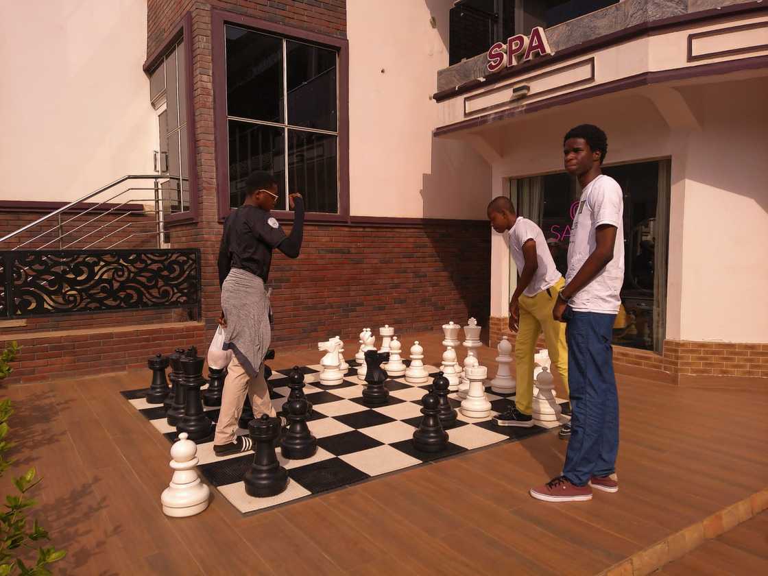 Dominican University Ibadan students playing chess on a very large chess set. Dominican University Ibadan students playing chess on a very large chess set.