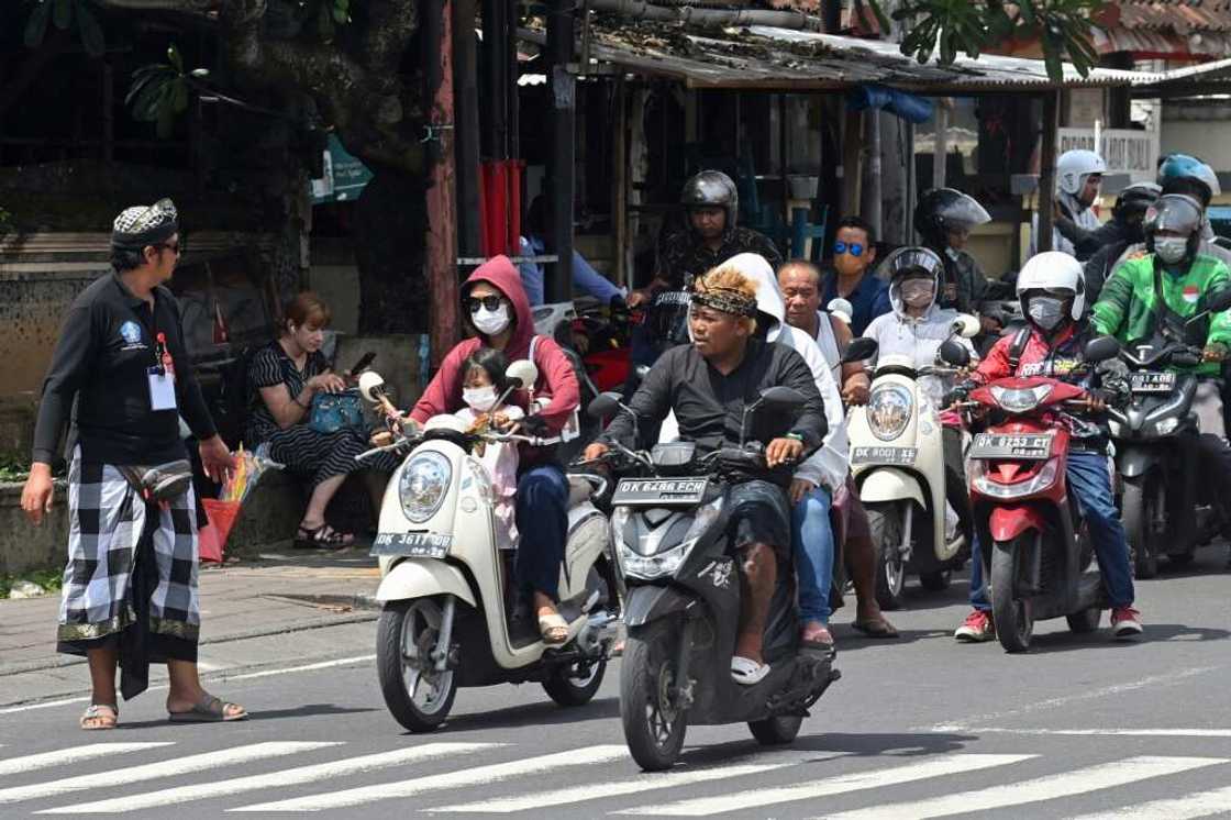 A security officer manages traffic as the motorcade of US President Joe Biden passes by during the G20 summit in Nusa Dua on the Indonesian resort island of Bali A security officer manages traffic as the motorcade of US President Joe Biden passes by during the G20 summit in Nusa Dua on the Indonesian resort island of Bali