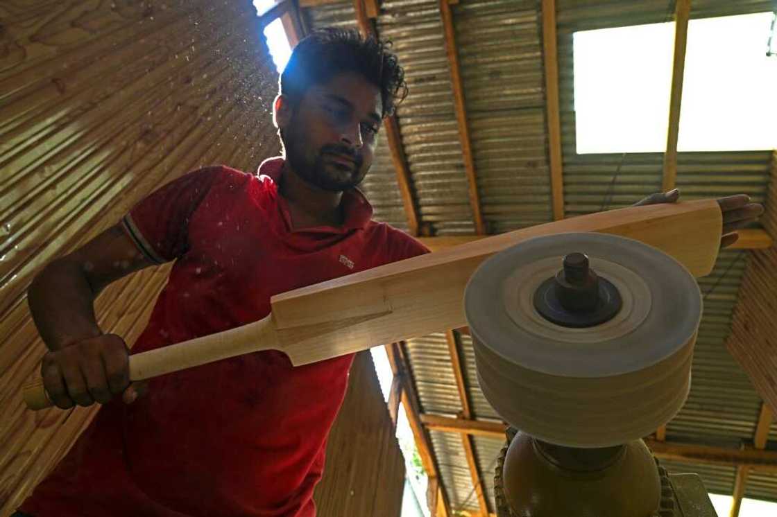 A worker crafts a Kashmiri willow wood cricket bat at a factory in Kashmir's Sangam village, on August 19, 2023 A worker crafts a Kashmiri willow wood cricket bat at a factory in Kashmir's Sangam village, on August 19, 2023