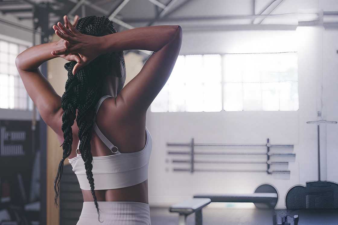 A black woman stands in a gym