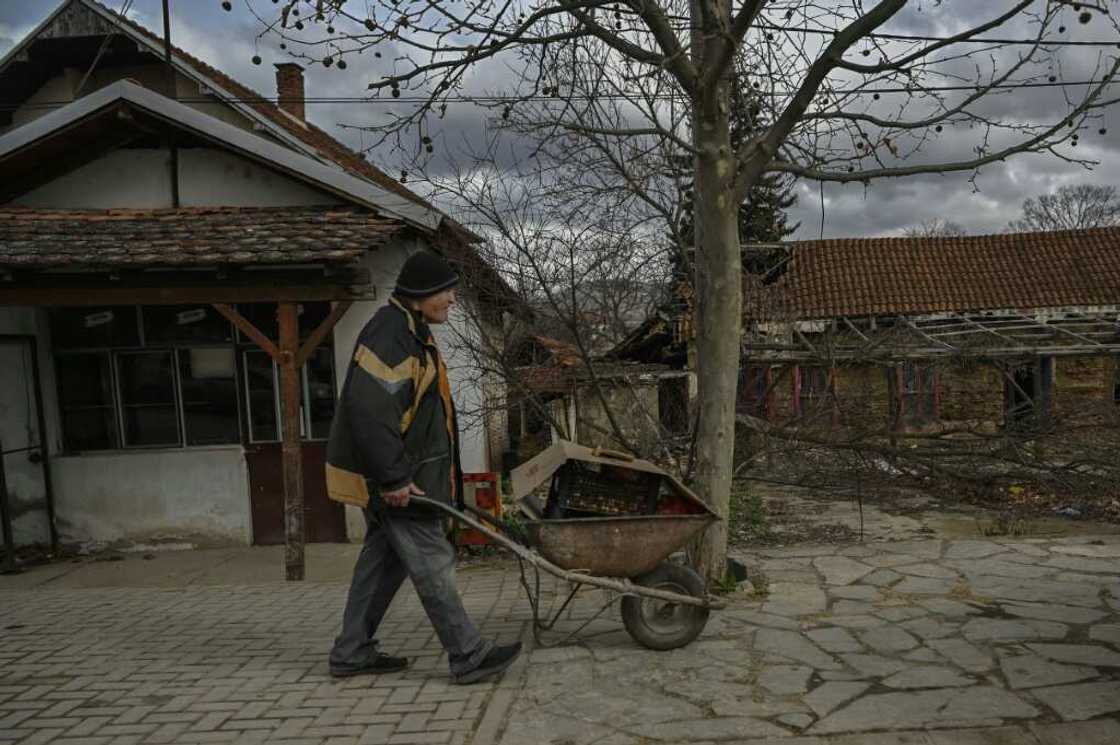 Stocking up: a Serbian man pushes a wheelbarrow through Gracanica, central Kosovo Stocking up: a Serbian man pushes a wheelbarrow through Gracanica, central Kosovo