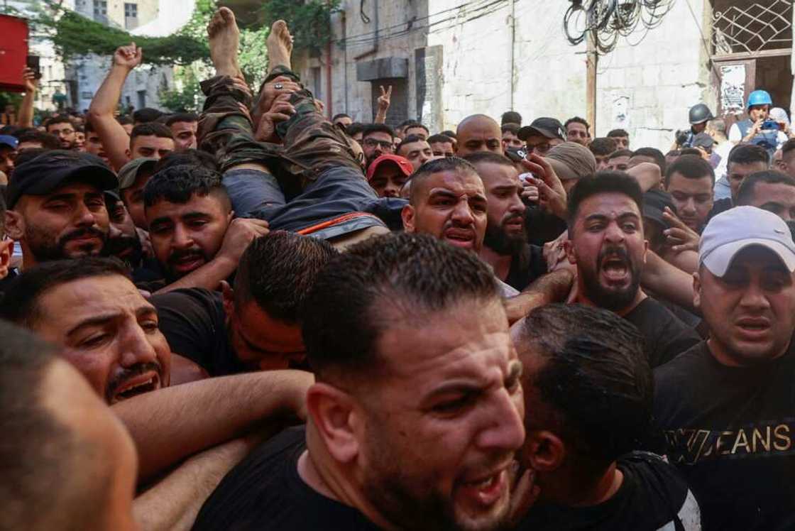 Palestinians evacuate a wounded gunman following clashes with the Israeli army during a raid in the West Bank city of Nablus Palestinians evacuate a wounded gunman following clashes with the Israeli army during a raid in the West Bank city of Nablus