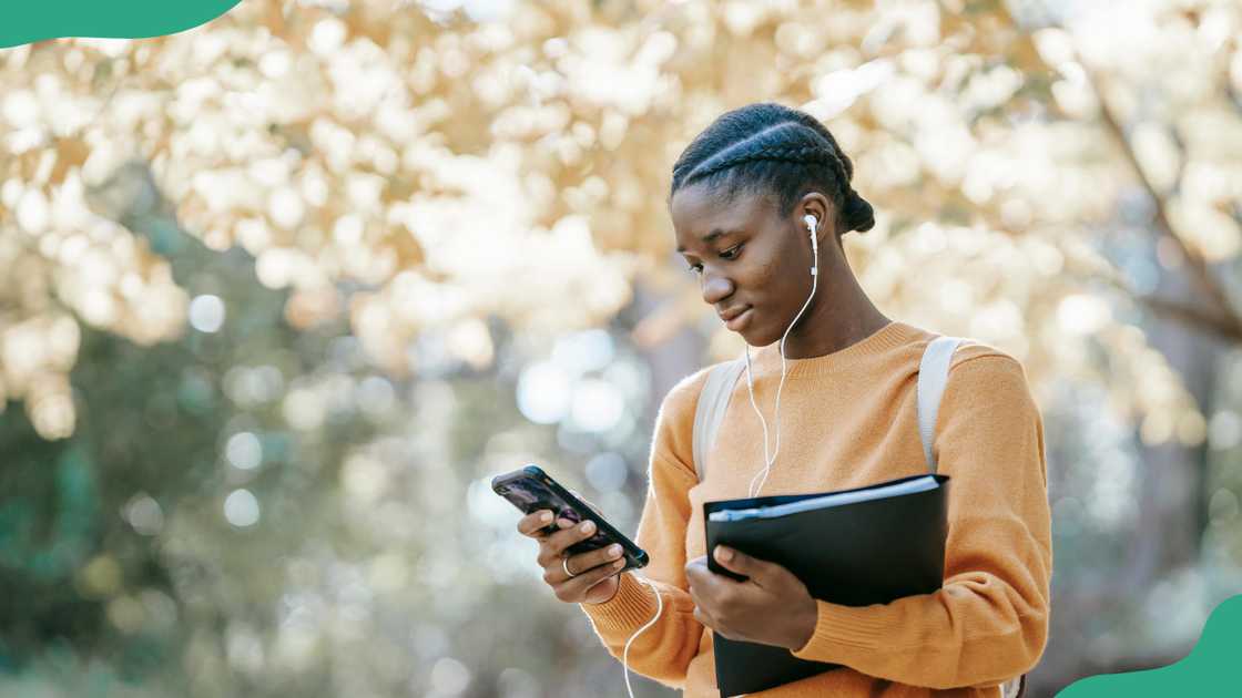 A female student uses her smartphone A female student uses her smartphone