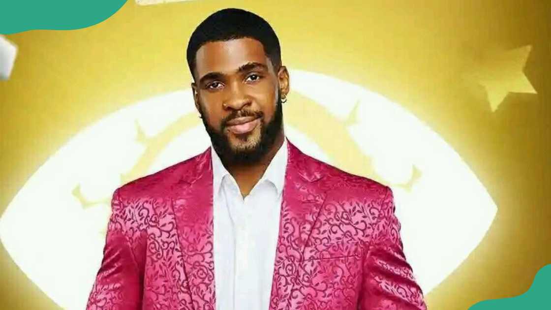 Bright Morgan in a patterned pink suit.