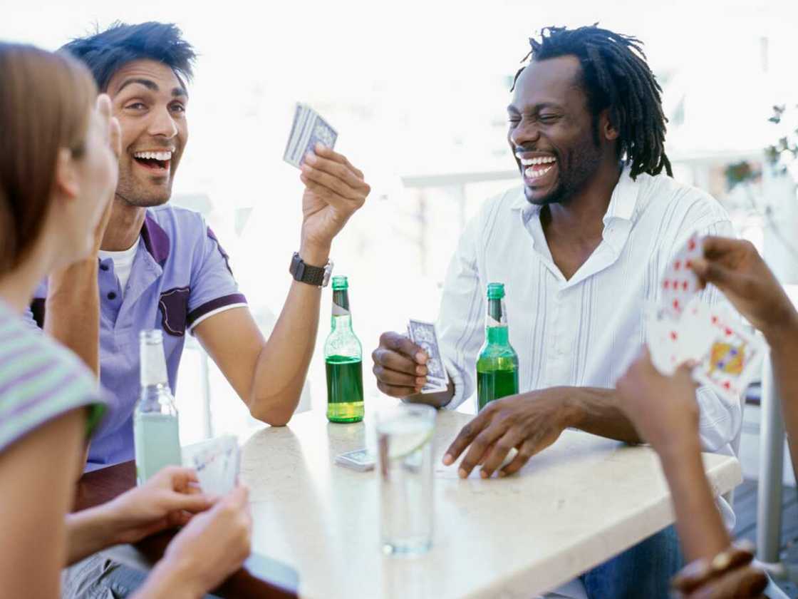 Four young people playing cards Four young people playing cards