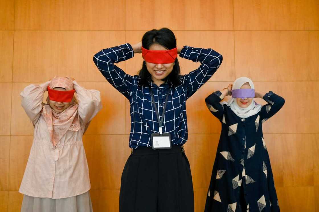 A family playing a blindfold game A family playing a blindfold game