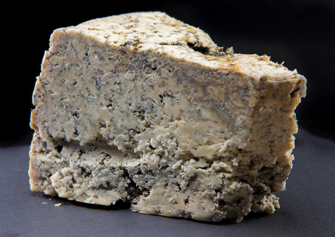 Cabrales cheese in black background. Cabrales cheese in black background.