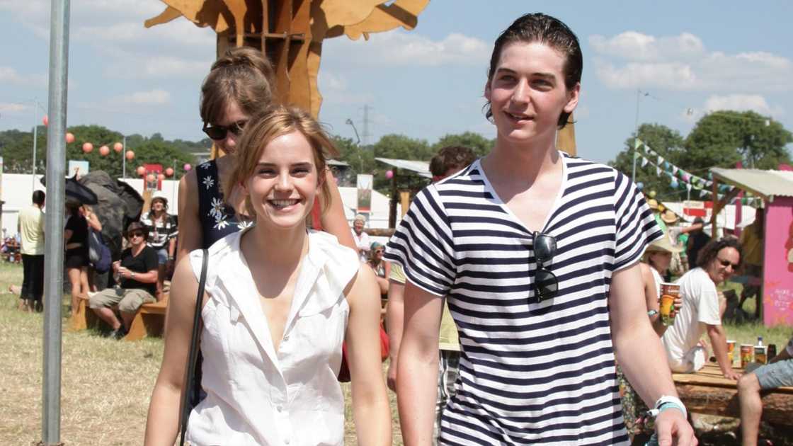 Emma Watson and George Craig walk together during the Glastonbury Festival in Somerset. Emma Watson and George Craig walk together during the Glastonbury Festival in Somerset.