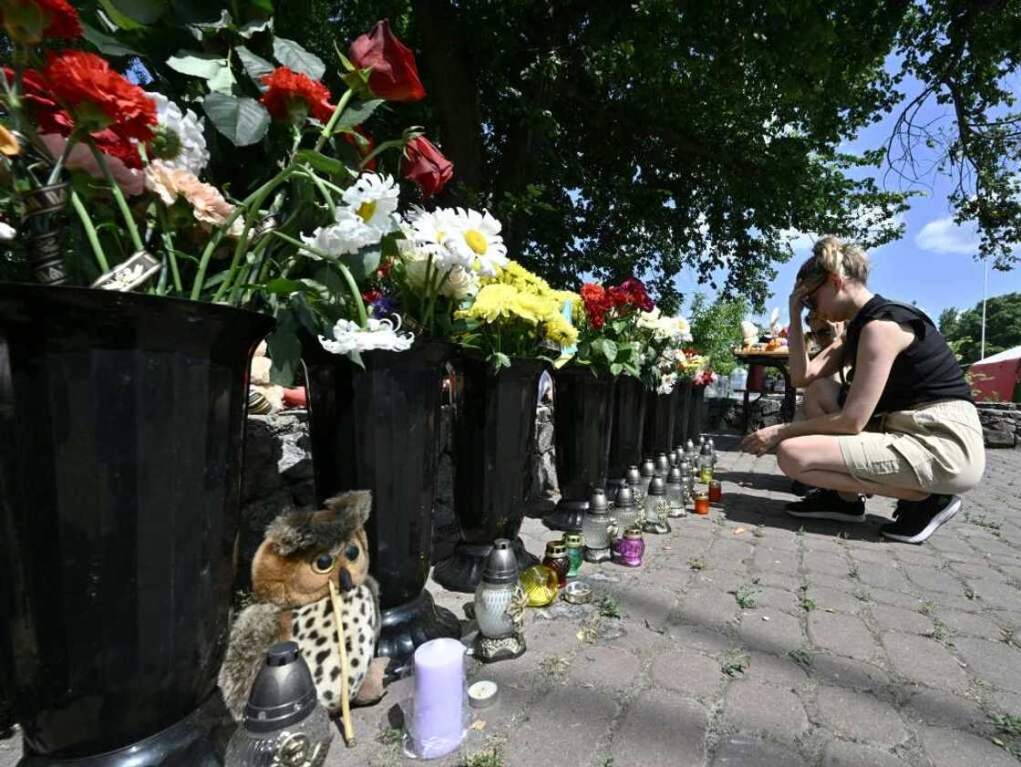 Local people laid flowers and left children's toys next to the burnt-out store Local people laid flowers and left children's toys next to the burnt-out store